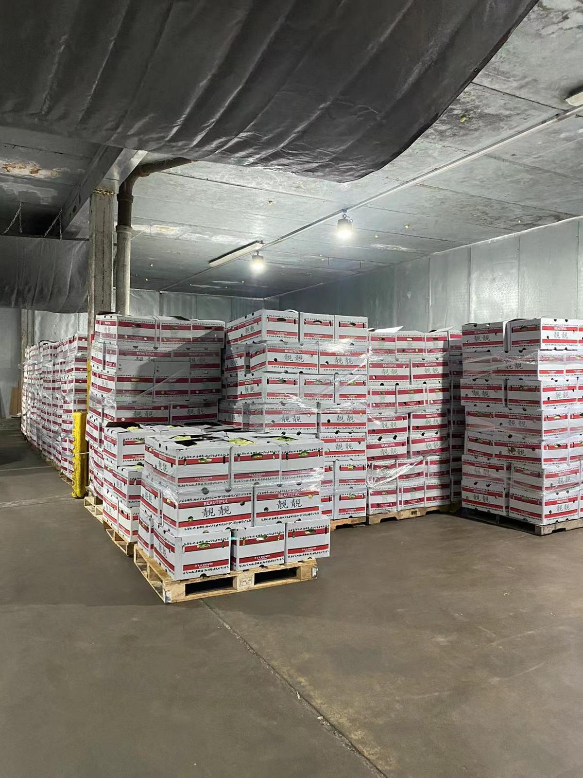 Stacked produce boxes inside the Dawn Produce cooler warehouse